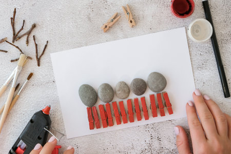 Diy Merry Christmas deer on greeting card postcard made of pebbles, sea stones, clothespins and...