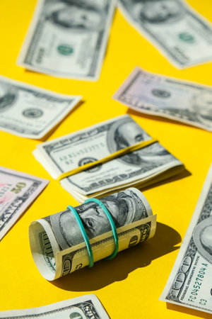 US dollars bundle close up isolated on dollar background. Paper denominations of dollars cash rolls...