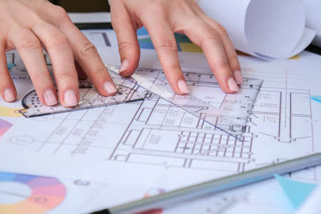 Hands use pencil with a protractor. Architectural Project drawings with tools. Architects workplace. Engineering Interior designer's working table. Workspaceの写真素材
