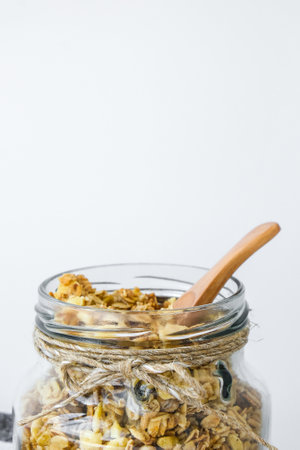 Healthy breakfast. Oatmeal Granola with greek yogurt and nuts banana muesli in jars on light background. Vegan, vegetarian and weight loss diet concept. Detox menu. Healthy eating foodの写真素材
