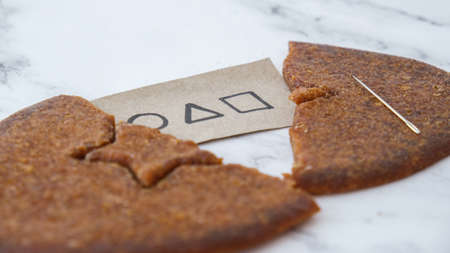 Kiev Ukraine - October 2021 squid game invitation card Star shape Homemade sugar candy. Playing...