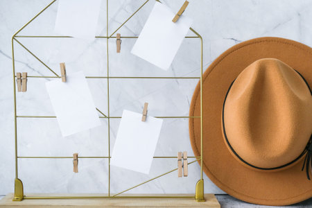 Cards and posters mock ups on grid board. Copy space. Feminine hipster office table decoration. Home office desktop. Freelance bloggers workplace. Cowboy hat decorの写真素材