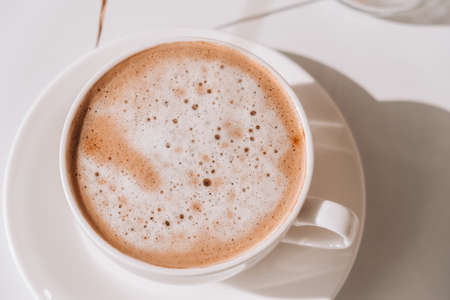 Pampas grass and white cup with coffee. Drinking Cappuccino in the breakfast morning at home. Flat lay. Wallpaper. Aestheticsの写真素材