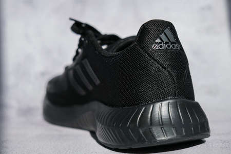 Kiev Ukraine - October 2021 Black Adidas sneakers on display. Multinational company. Product shots. Adidas swift run shoes for running for woman - illustrative editorialのeditorial素材