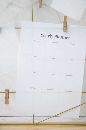 YEARLY PLANNER Cards and posters mock ups on grid board. Copy space. Home office desktop. Freelance bloggers workplace. Brushes and palette tools Creativeの写真素材