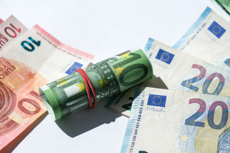 Close up of Euro money roll. Euro banknote set cash money - EU currency. Rolled with rubber euro...