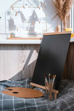 Stylish artist of freelancer. Easel Conceptual interior without people Balcony workplace. Watercolor...