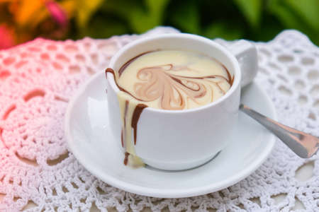 Hot chocolate cup on table at cafe outdoors summer. Coffee time and breakfast in restaurant....
