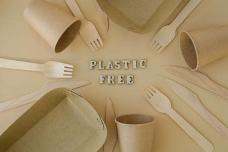 PLASTIC FREE text around Eco friendly, disposable, recyclable, compostable tableware. Paper food boxes, dishes on neutral beige background. sustainable lifestyle concept. Flat lay earth tonesの写真素材
