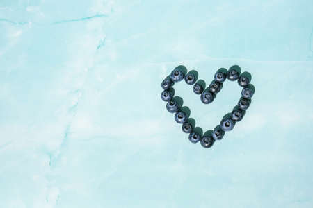 Heart made of Fresh blueberries. Blueberry antioxidant organic superfood concept for healthy eating and nutrition. Harvesting conceptの写真素材