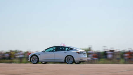 Kiev Ukraine July 2021 Two cars start the race. Close-up wheels. Tesla Electric car. E-Drive. Electric vehicle drives. Car raceのeditorial素材