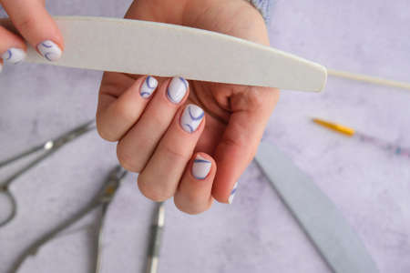 Professional stylish trendy blue Hardware Manicure. Procedure for the preparation of nails. Cuticle...