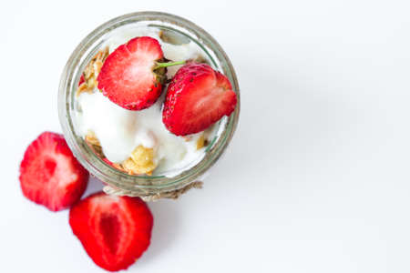 Healthy breakfast. Oatmeal Granola with greek yogurt and nuts strawberry muesli in jars on light background. Vegan, vegetarian and weight loss diet concept. Detox menu. Healthy foodの写真素材