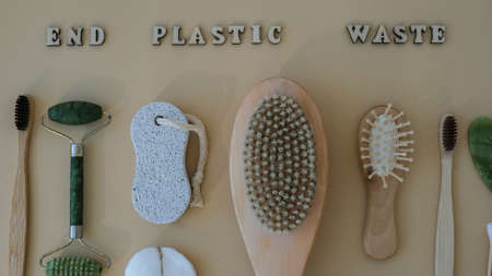 END PLASTIC WASTE text around Natural skin care products on neutral beige background, flat lay....