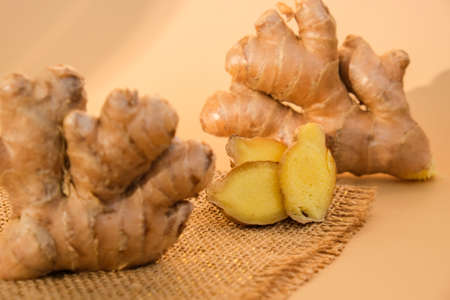 Fresh organic ginger rhizome root used in traditional medicines. Creative photo Earth tones natural...
