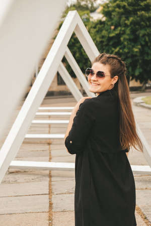Portrait of young millennial woman on street. Hippie lifestyle. Happy smiling woman. Outdoors....