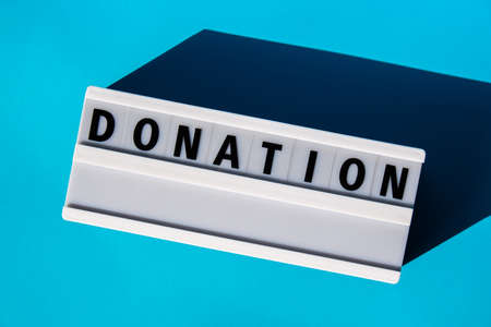 Lightbox with text DONATION. Motivational Words Quotes Concept. colorful blue background. Minimal creative concept. Donation supportの写真素材