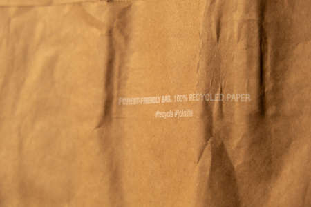 Forest friendly bag Brown paper bag that is 100 recyclable and reusable spbd. Printed plea for user to recycle and reuse this bag as a form of packaging. Symbol indicates paper and cardboard. Concept: ecology Special mark on product guarantees environmental safety of the entire production life cycle - from raw materialsの写真素材