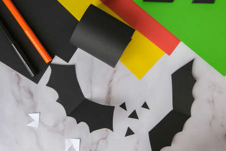 paper bats. Halloween holiday decorations. Flat lay, top view Happy Halloween party concept. children's art project. DIY concept. Step by step Craft ideasの写真素材