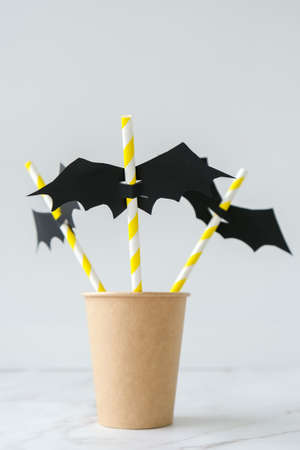Black paper bat on drinking straw. Halloween party decoration. DIY for children craft. Autumn october holiday Trick or treatの写真素材