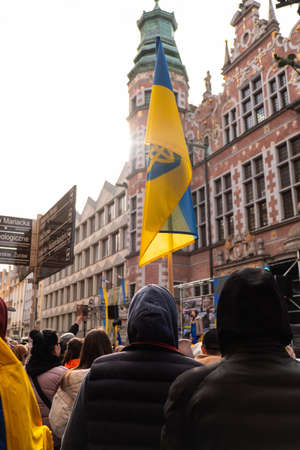 Gdansk Poland March 2022 Protest manifestation against war. Anti-war demonstration Ukrainian flag in...