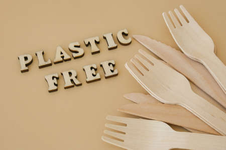 PLASTIC FREE text around Eco friendly, disposable, recyclable, compostable tableware. Paper food boxes, dishes on neutral beige background. sustainable lifestyle concept. Flat lay earth tonesの写真素材