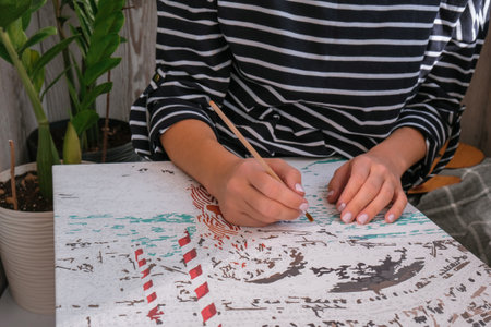 Female hands coloring canvas Picture by numbers Creative hobby. Painting for beginners. Leisure activity for stay home lockdown, anti-stress idea. Meditation, relax concept. Mindfulness activityの写真素材