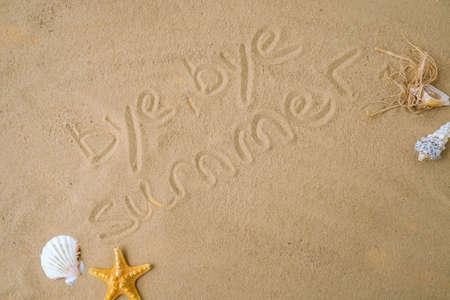 Composition with text BYE BYE SUMMER seashells, pebbles, mockup on sand background. Blank, top view, still life, flat lay. Sea vacation travel concept tourism and resorts. summer holidaysの写真素材