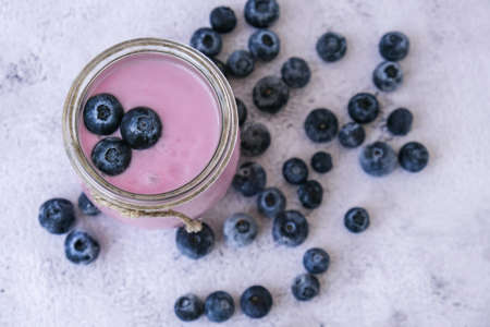 Bowl with yogurt and blueberries on table. Blueberry yogurt with fresh blueberries. Healthy...