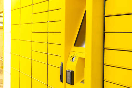 Modern yellow shopping locker. Bar code reader for Skans QR Code on Mobile phone Self-service Locker Cell Modern Shipping and Delivery Concept with Contactless Automated Postal Box. Parcel Lockerの写真素材