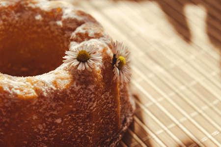 Cupcake decorated chamomile flower In the rustic style. Authentic photo. Easter concept greeting card background. Sun rays Homemade baked concept. Summer, Spring time recipeの写真素材