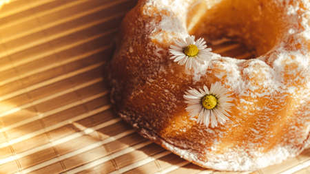 Cupcake decorated chamomile flower In the rustic style. Authentic photo. Easter concept greeting...