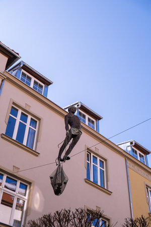 SOPOT POLAND - May 2022 Sculpture of boy-fisherman balancing on the rope between two buildings exterior. Monte Cassino Street Statue. Travel tourist destinationのeditorial素材