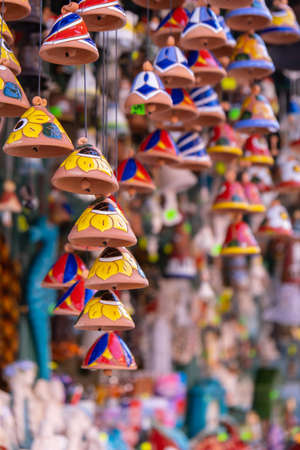 Ceramic handycrafts sold in the shops sold in Sopot Poland. Candid souvenir travel gifts. Clay bells hang on a rope. Shallow depth of fieldの写真素材