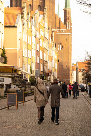 Gdansk Poland May 2022 couple of tourists walking in City hall at Square Travelers discover Ancient architecture of old town in Gdansk Poland. Travel destinationのeditorial素材