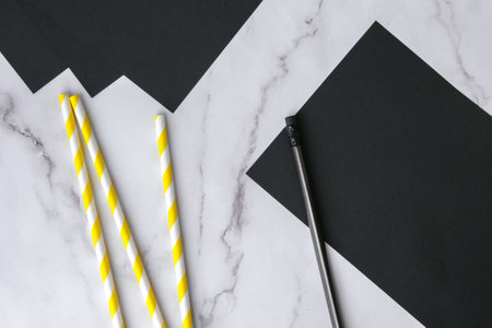Striped drinking straws with paper bats. Halloween holiday decorations. Flat lay, top view Happy Halloween party concept. children's art project. DIY concept. Step by step Craft ideasの写真素材