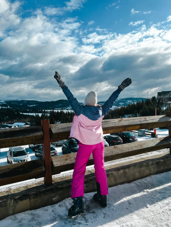 Bukovel Ukraine - February 2022 Skier woman on the ski slope resting relaxing extreme recreation active lifestyle activity. Female skier on a slope in the mountains. Winter active sportのeditorial素材