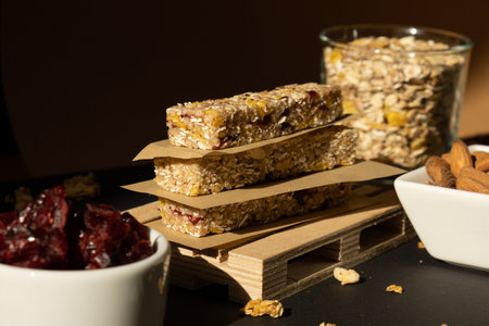 Homemade natural Granola energy bar. Variety of homemade Protein granola breakfast bars ingredients nuts, raisins dried cherries and chocolate. Healthy nutrition eating. Gluten free cereal dieting snack super food Sport oatmeal bar Vegan dessert conceptの写真素材