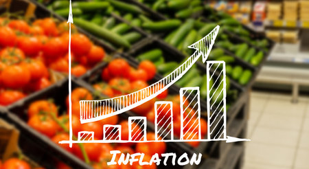 Wooden information label sign with text INFLATION with graph against defocused store shelves...