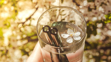 Reusable glass Straws on nature background with green leafs spring flowers Eco-Friendly. Zero waste,...