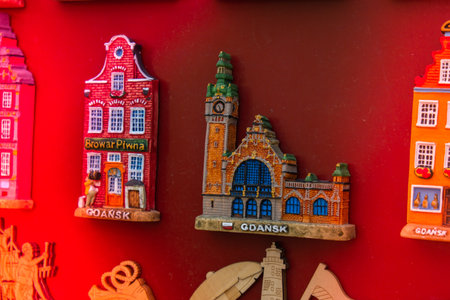 Rows of fridge magnet souvenirs from Gdansk displayed on stillage. Model houses magnets on display...