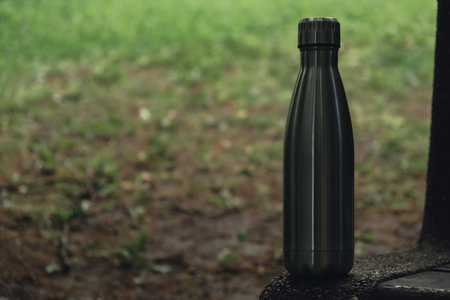 Water bottle. Reusable steel thermo water bottle on wooden bench. Sustainable lifestyle. Plastic free zero waste free living. Go green Environment protectionの写真素材