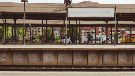 Gdansk Poland May 2022 People waiting for trains on platform at Gdansk Glowny railway station. Polish intercity train. Travel tourist concept. People travelling SKM Polish: Szybka Kolej Miejskaのeditorial素材