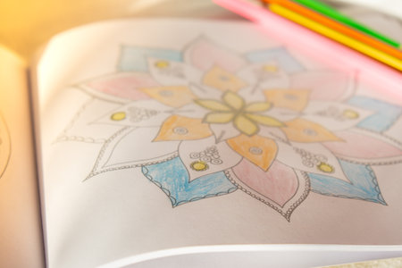 Mandalas antistress page to combat stress. Relaxing hobby mental wellbeing and art therapy. Meditative process of coloring pages. Self expression by artの写真素材