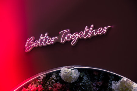 BETTER TOGETHER inscription in neon lights at night. Electric sign at night nightlife concept. Modern fluorescent life style luminescent. LED light sign textの写真素材