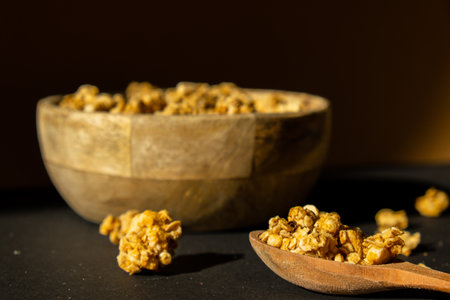 Homemade granola with nuts and seeds in eco tableware wooden bowl. Healthy snack on breakfast....