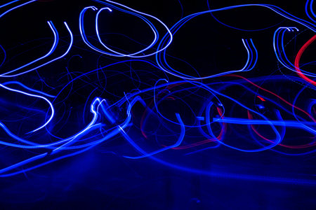 Long exposure, light painting photography, multi color swirl effect against black background. night...