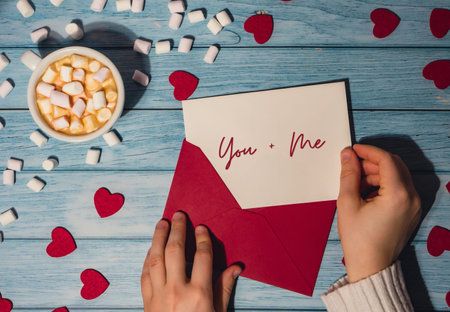 YOU plus ME text on valentine card inscription positive quote phrase Female hands holding valentine...