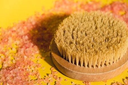 Dry massage brush with natural bristle, ecological cosmetics, home care. Natural sea salt Bamboo Brush for dry anti-cellulite massage. Spa beauty conceptの写真素材