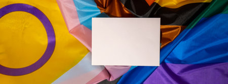 Banner Empty paper blank on Rainbow LGBTQIA flag made from silk material. Mock up template copy space for your text. Symbol of LGBTQ pride month. Equal rights. peace and freedom. Support LGBTQIA community. diversity equalityの写真素材